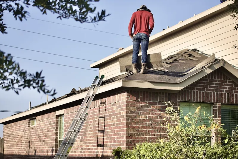 Professional roofer working on a residential roof in Wolfpit